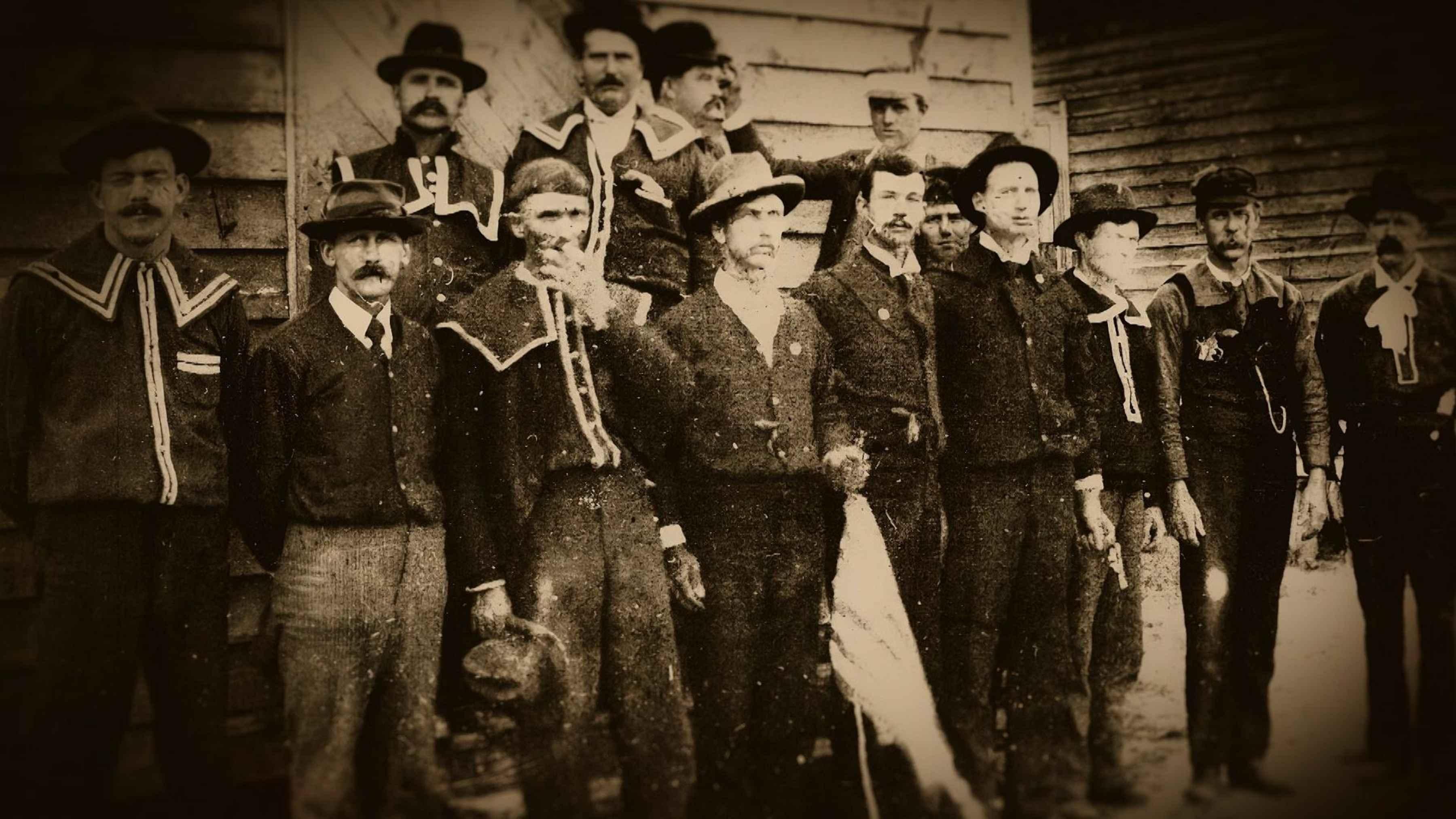 Sepia-toned image of white men lined up outside.