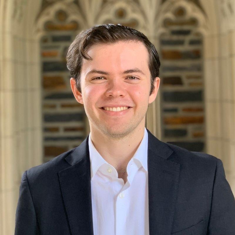 Matthew Norman in a suit jacket and white button up.
