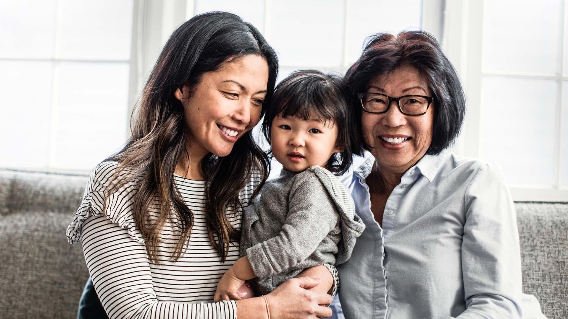 Grandma, mom , and child smiling