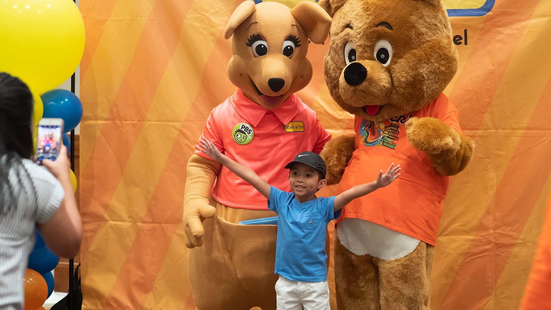 child with readaroo hapily posing